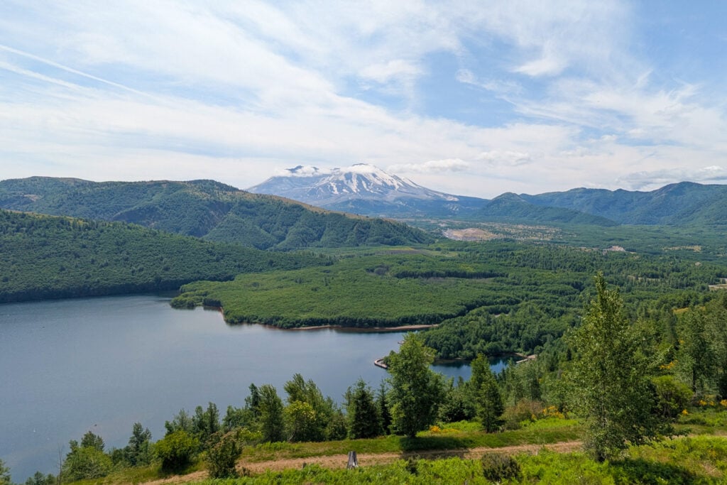 view of Mount St. Helens in the distance behind lake