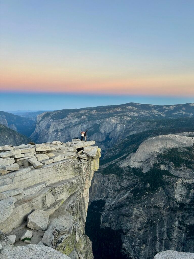 people standing on cliff edge