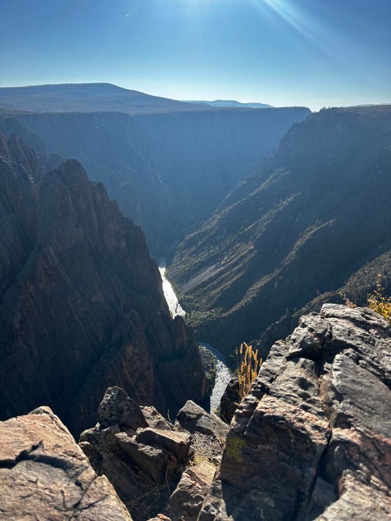 Black canyon with a river flowing through the bottom of it