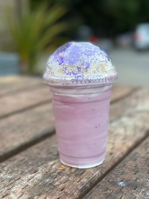 pink shake with whipped cream and purple sprinkles