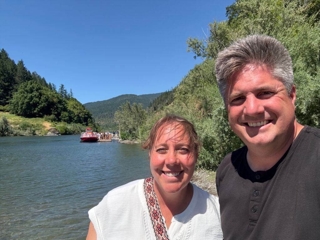 Man and woman standing in front of the Rogue River in Oregon