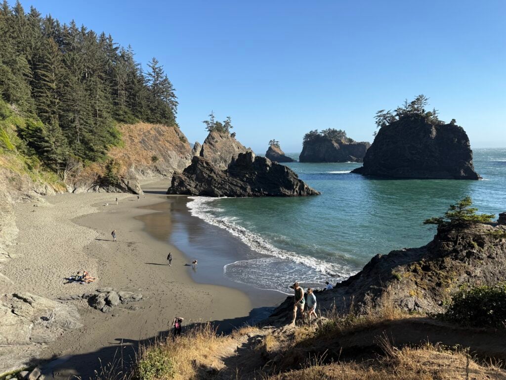 beach inlet from distance with people walking