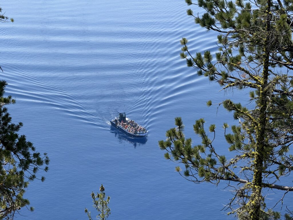Open air boat going across crater lake