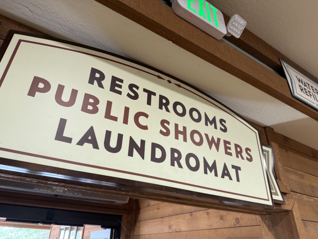 Sign saying restrooms, public showers, laundromat