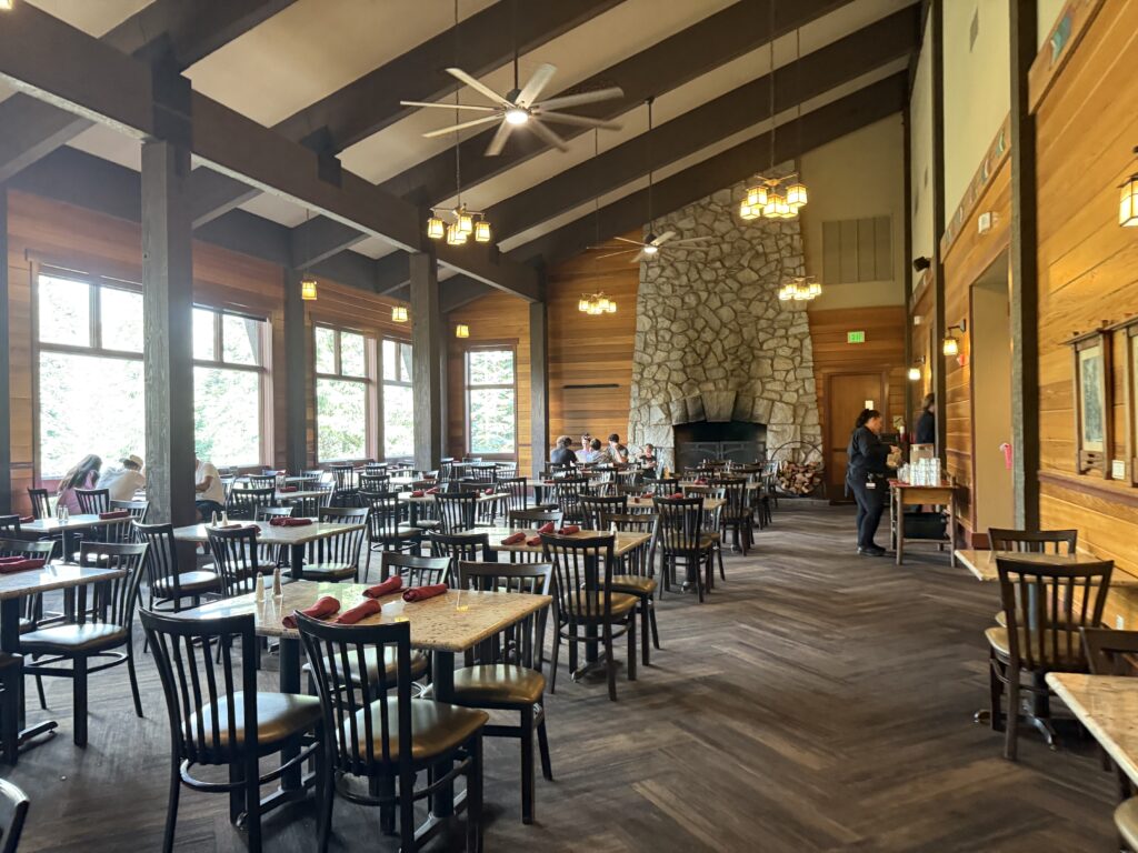 Formal dining room with large windows and stone fireplace