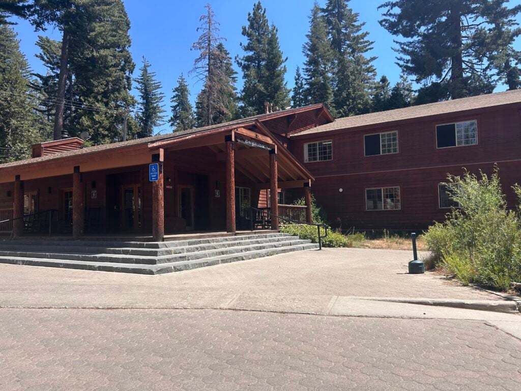Large wooden lodge surrounded by pine trees