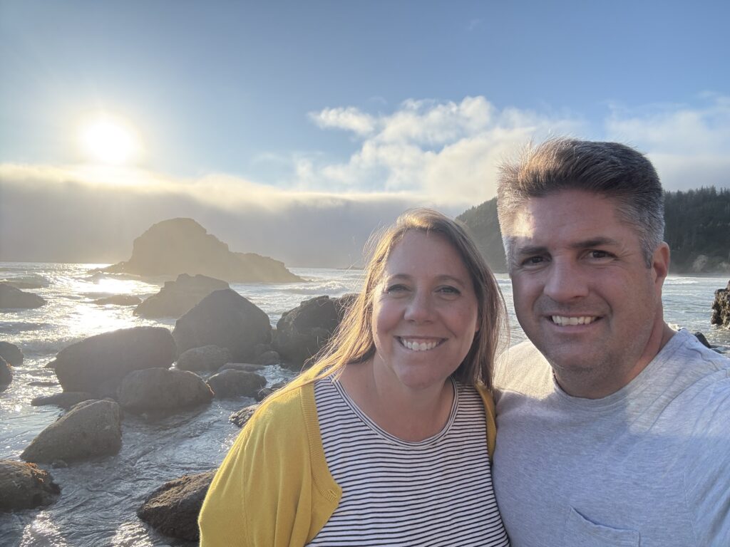 man and woman on beach at sunset