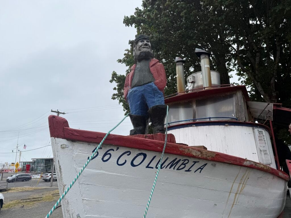 Bowpicker restaurant-old boat with statue of sailor on front