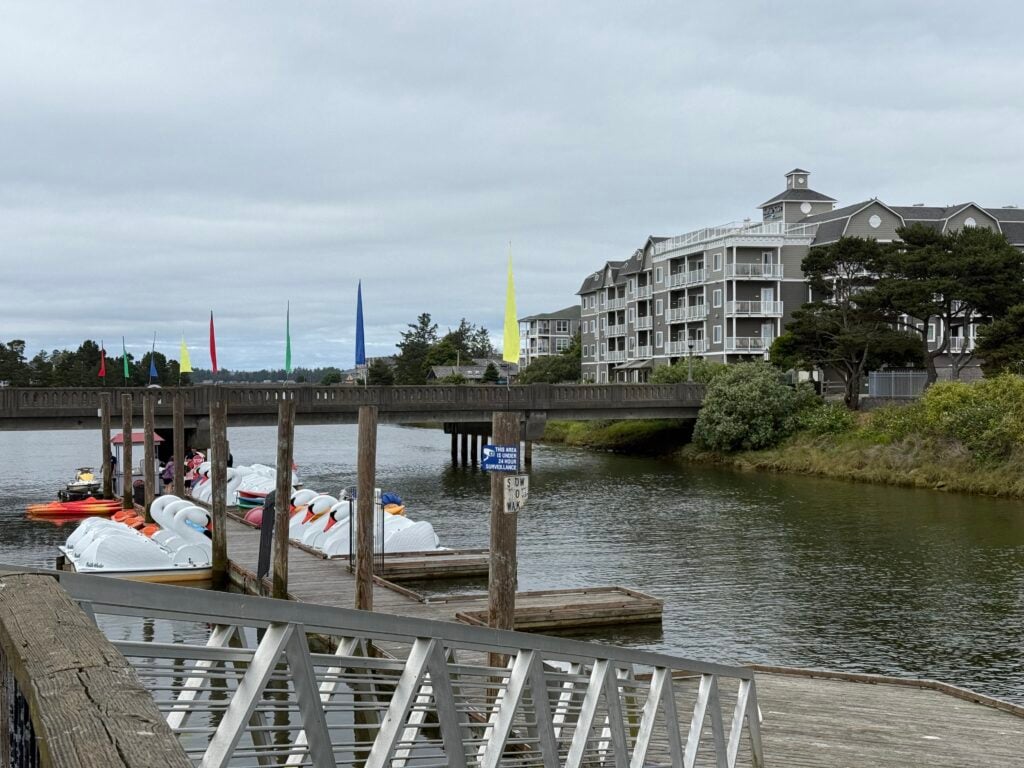 paddleboats at dock on river with hotel behind
