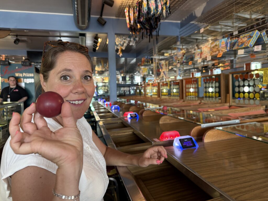 woman holding ball and playing carnival game