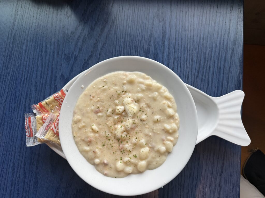chowder in bowl shaped like a fish with crackers on the side