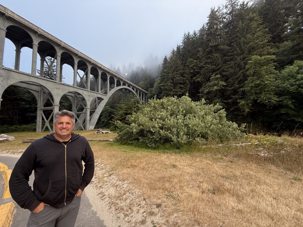 man in front of bridge