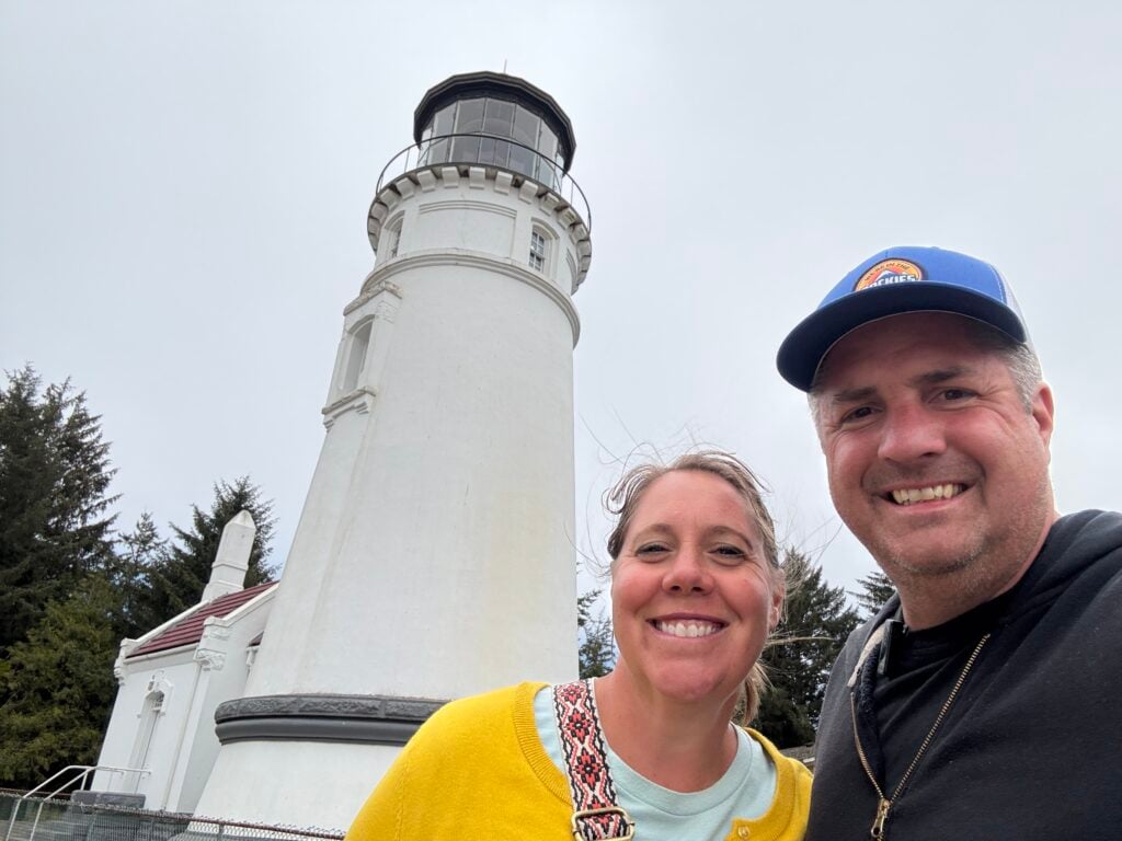 man and woman in front of lighthouse