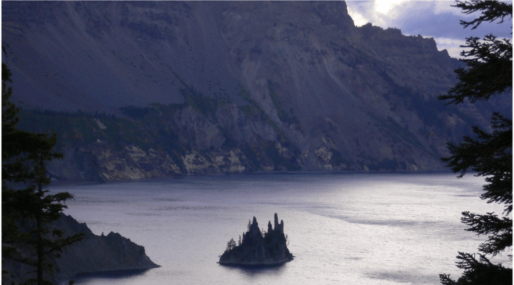 Black spires sticking out of a lake that look like a ship