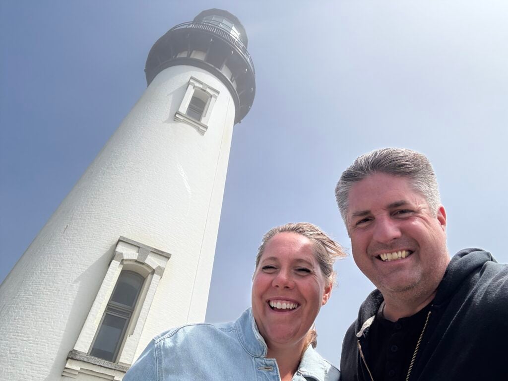 couple in front of lighthouse