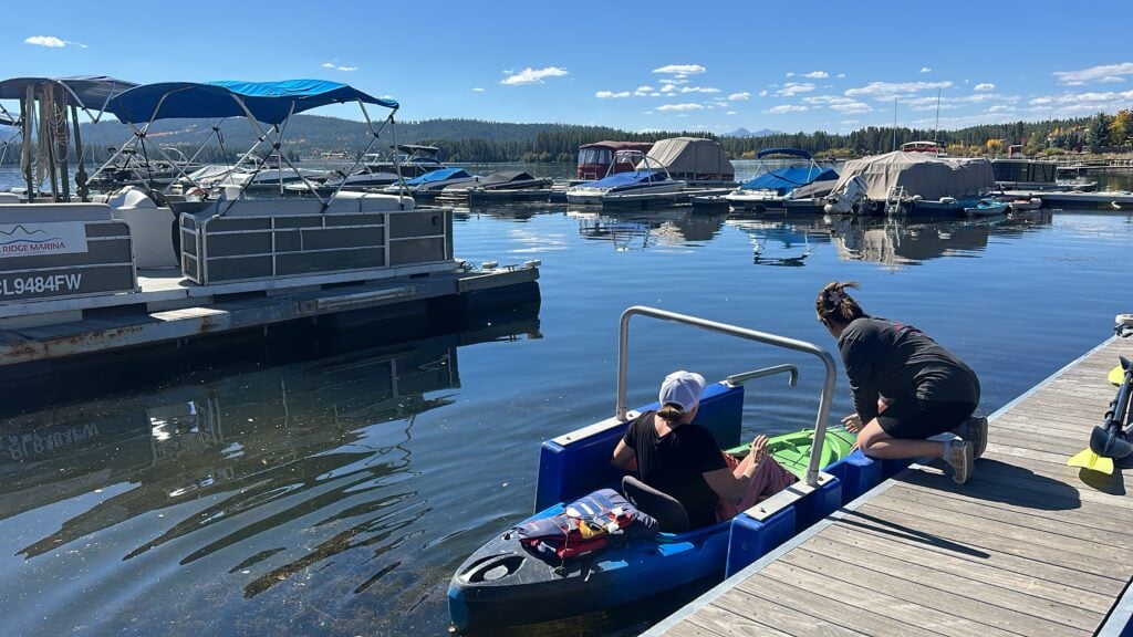 woman getting in kayak in Grand Lake marina