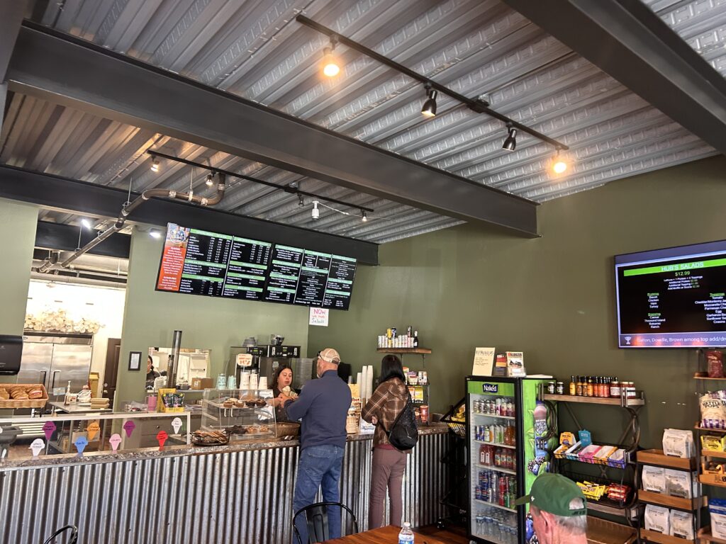 people ordering food at front counter in cafe