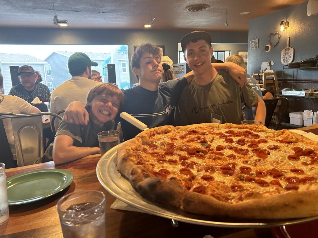 boys eating pepperoni pizza 
