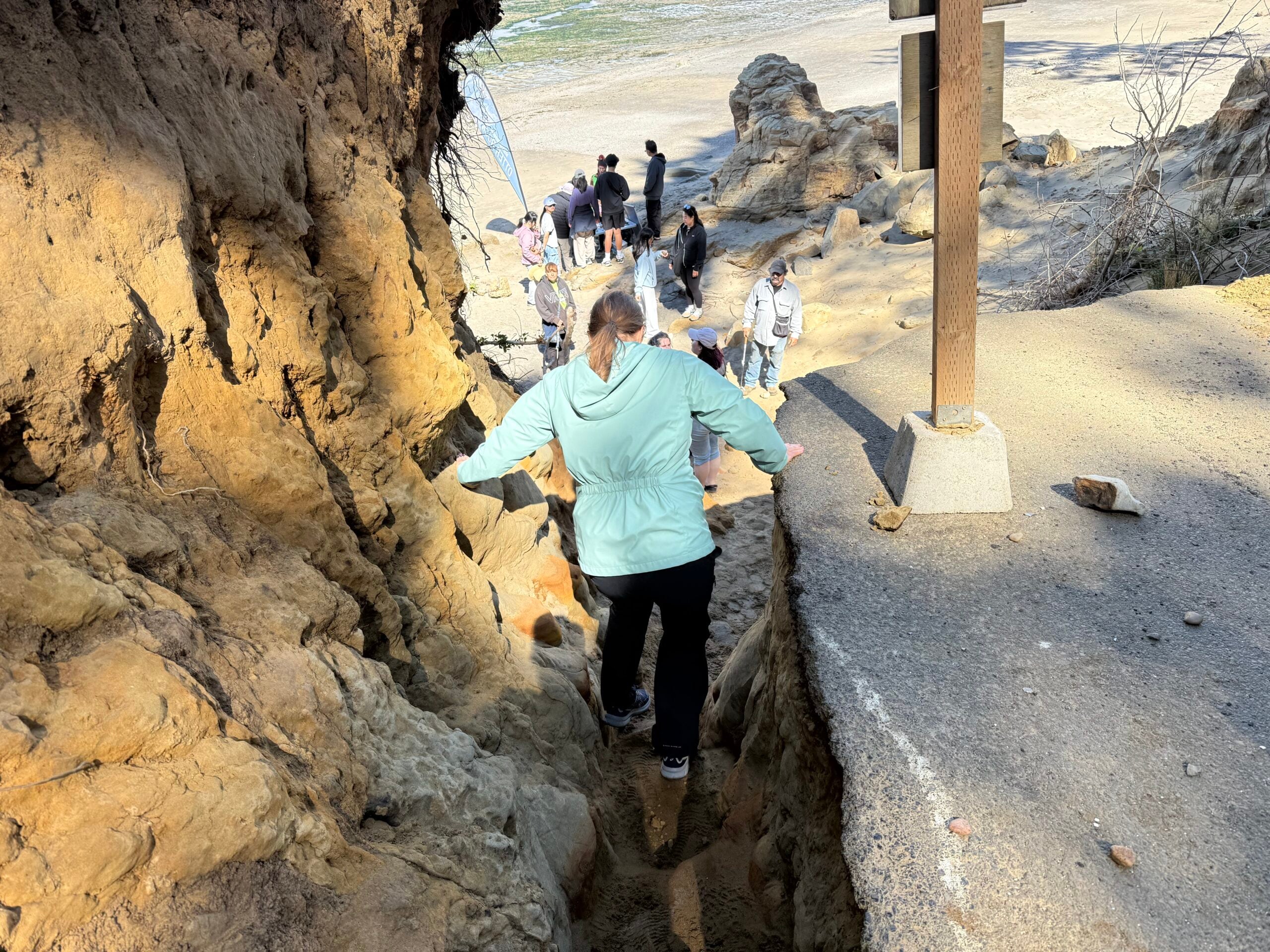 people walking on steep path to beach