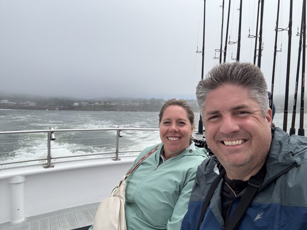 man and woman on whale watching tour boat