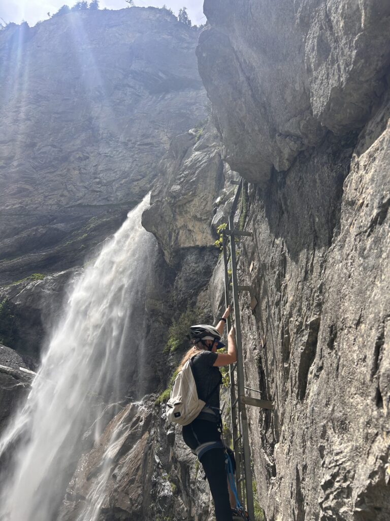 woman on via ferrata on cliff