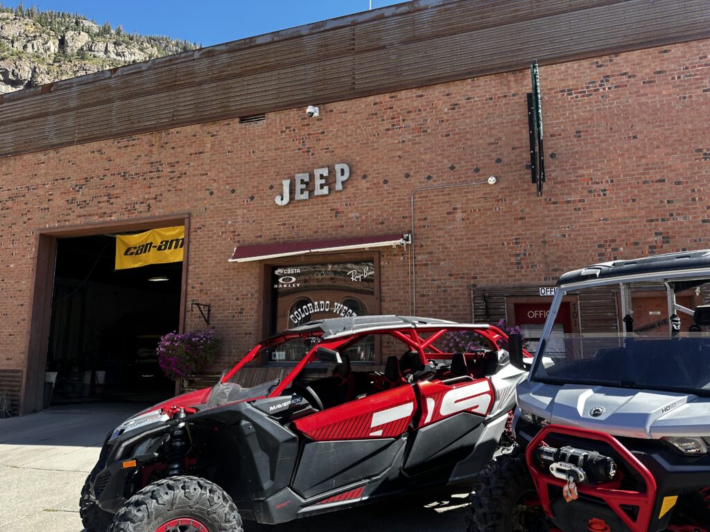 off-road vehicle in front of building