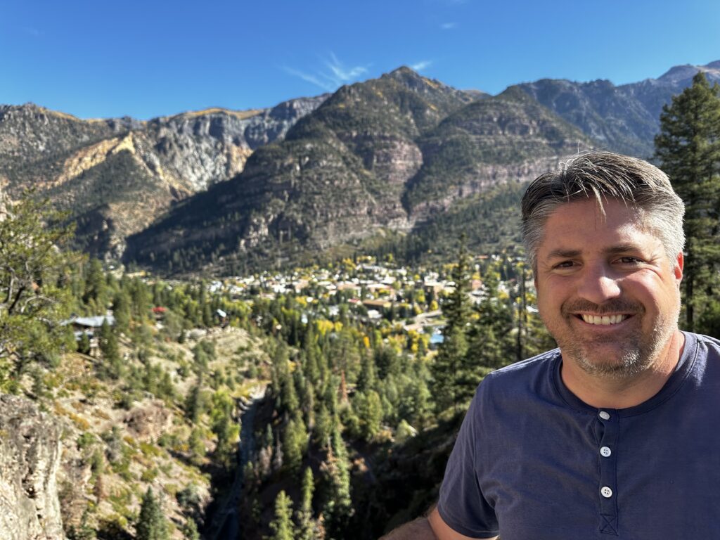 man with view of town behind