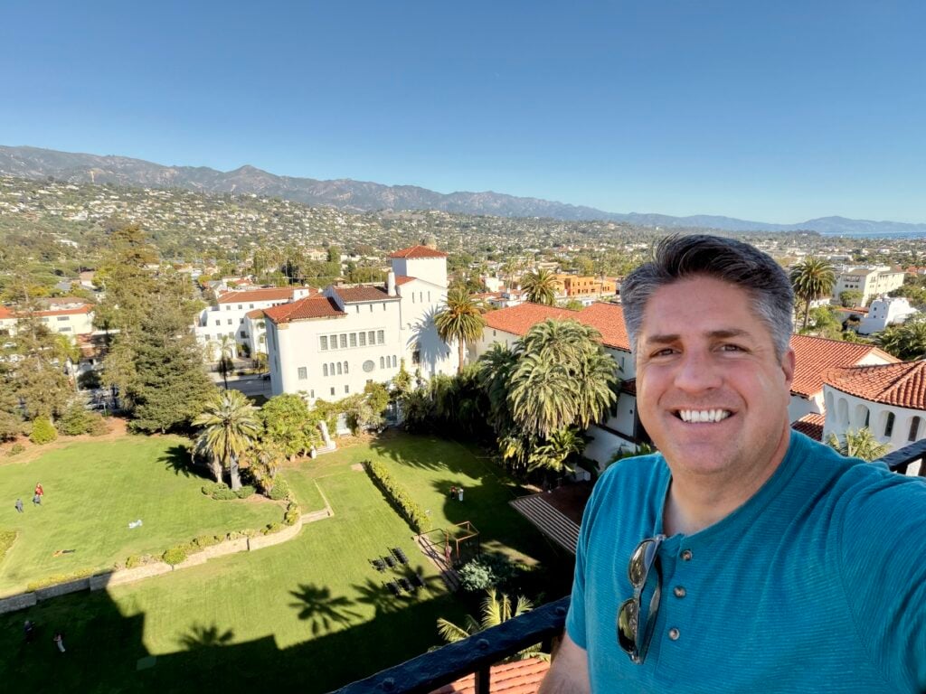 man taking selfie with view from tower