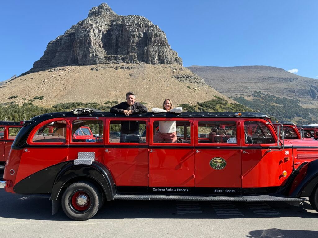 people standing in red bus in Glacier NP