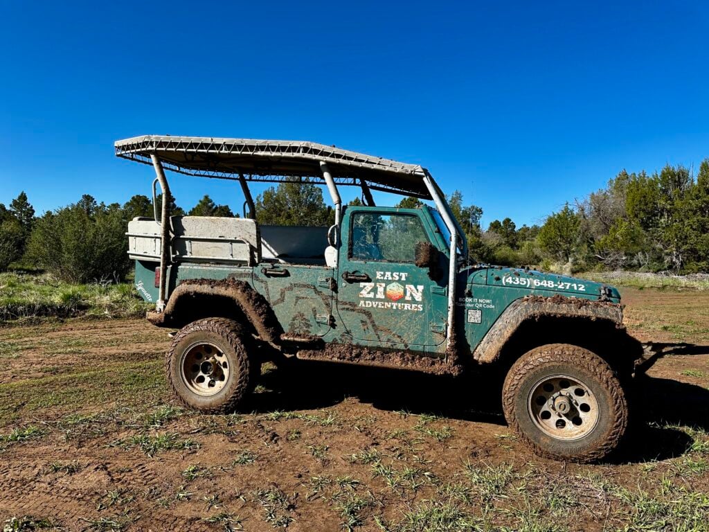 jeep shuttle covered in mud