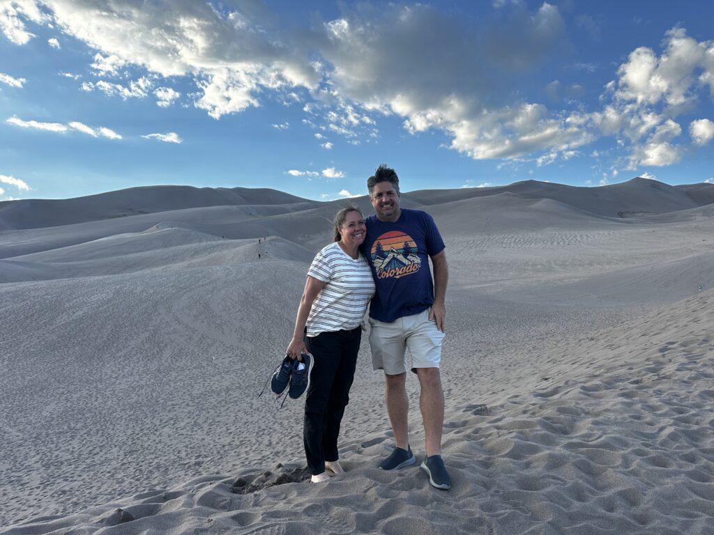 man and woman in the sand dunes