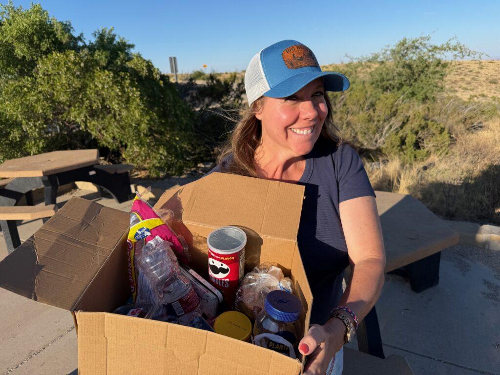 woman holding box full of food