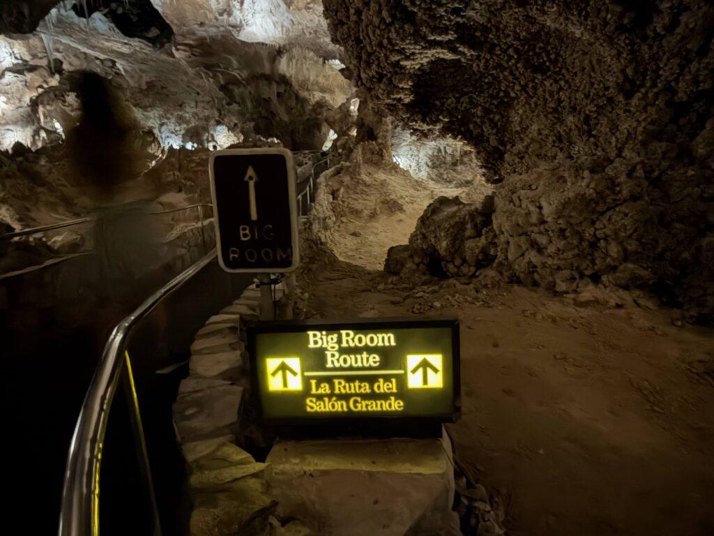 illuminated signs and pathway in cave