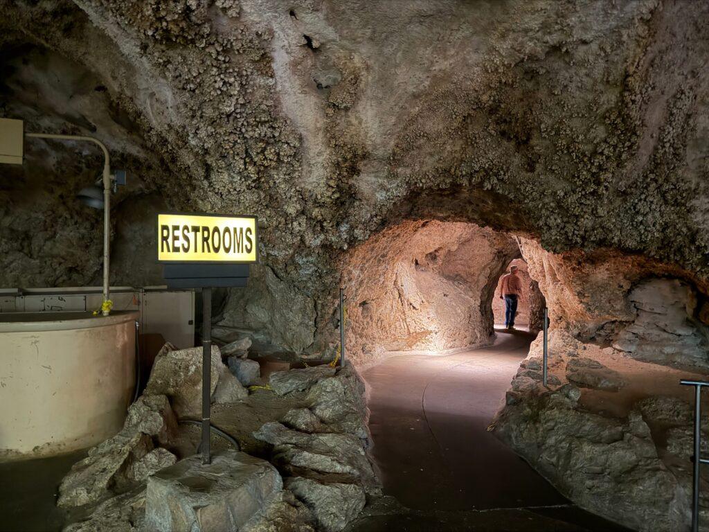 illuminated restroom sign in cave