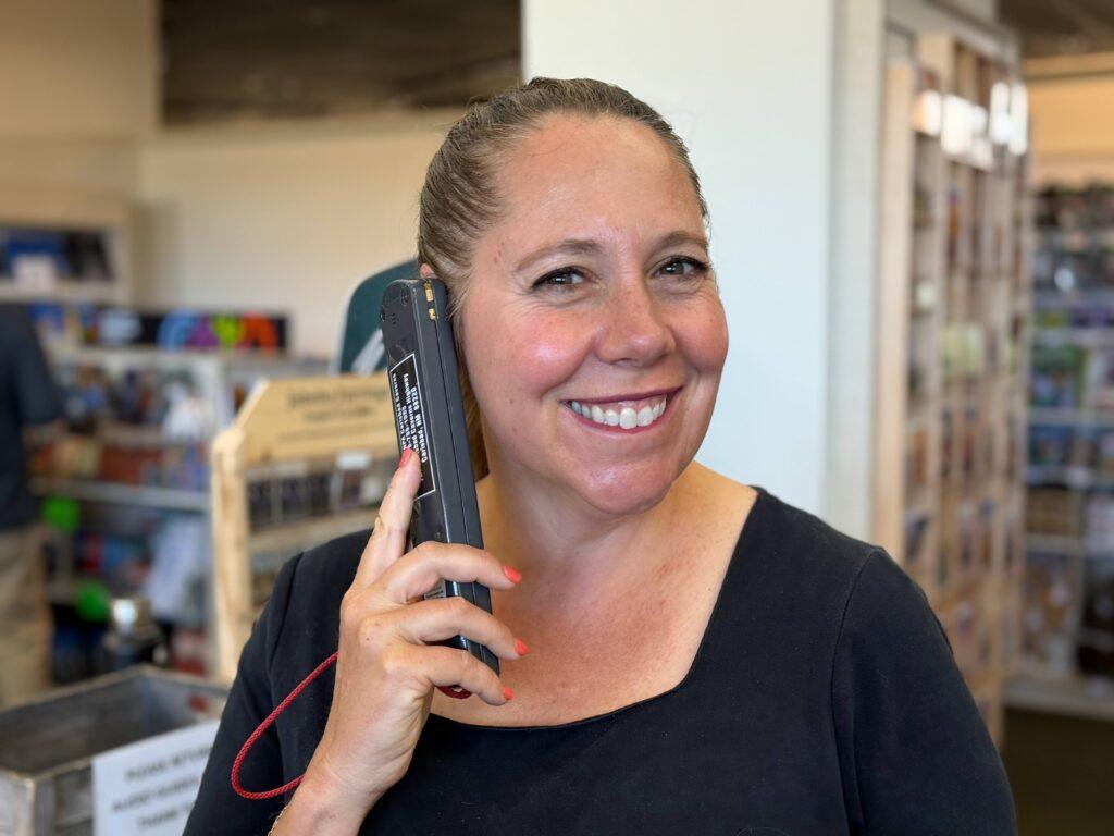 woman listening to audio guide on device