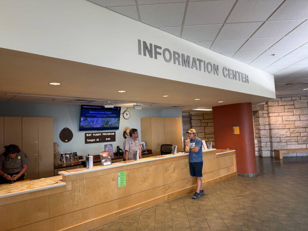 ranger talking to man at informational center