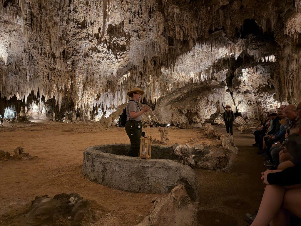 ranger speaking to people in cave