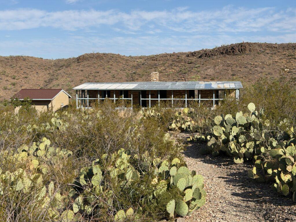 house in desert with cacti out front