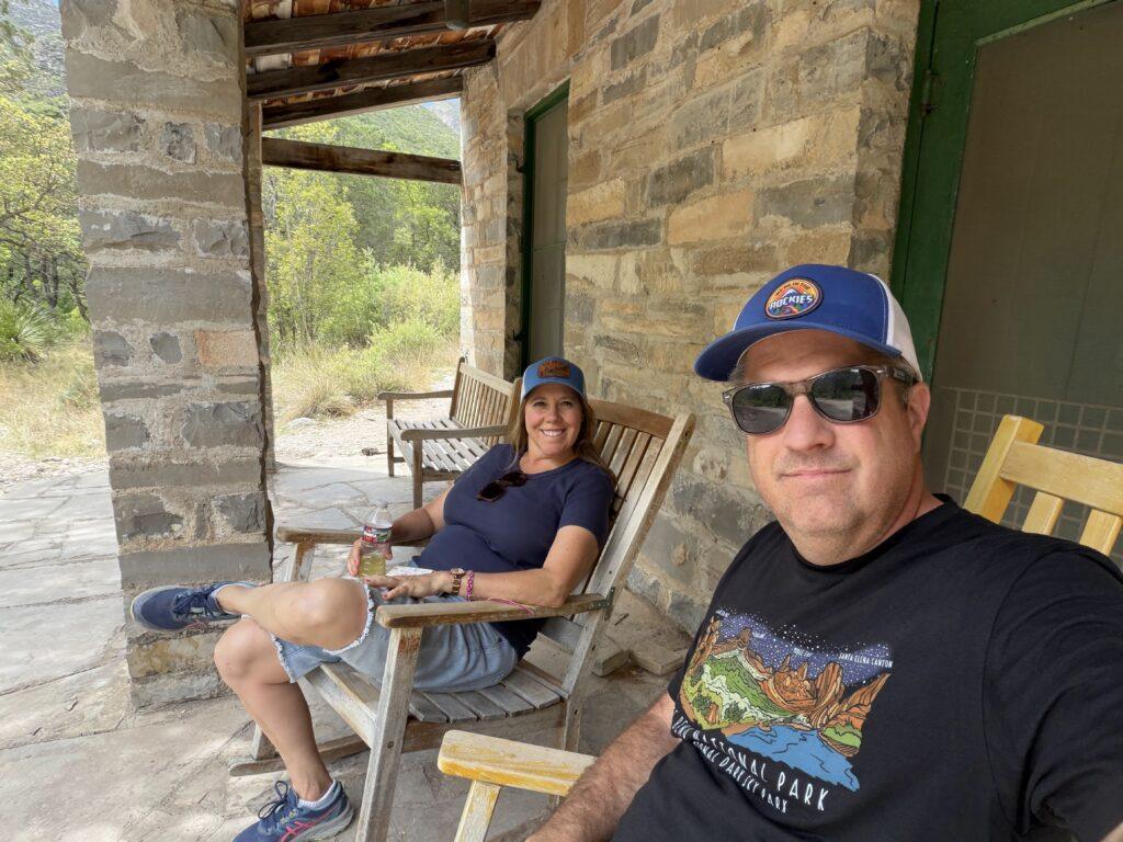 couple sitting on rocking chairs on front porch