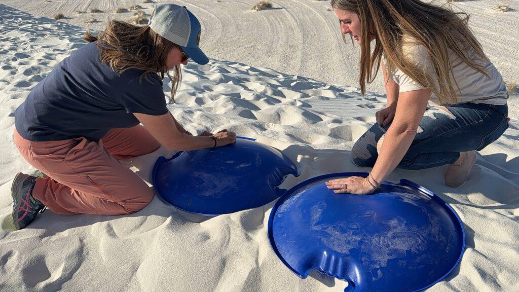 ladies waxing their round sand sleds
