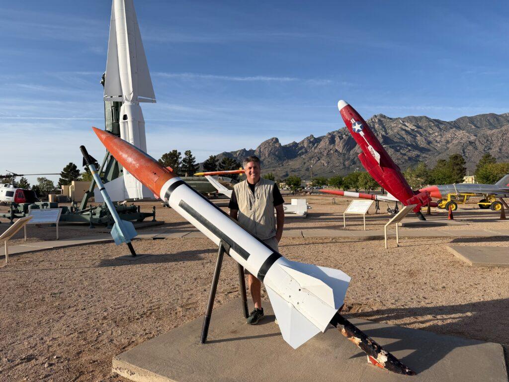 man standing among missiles at testing range