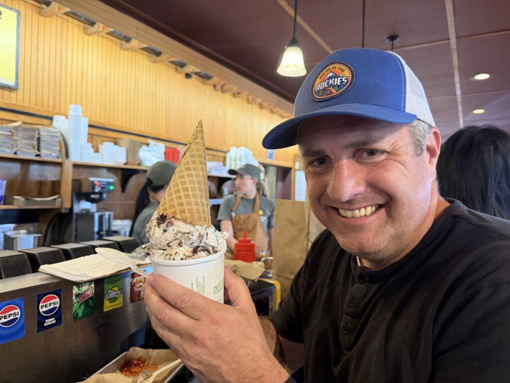 man holding ice cream cone in bowl