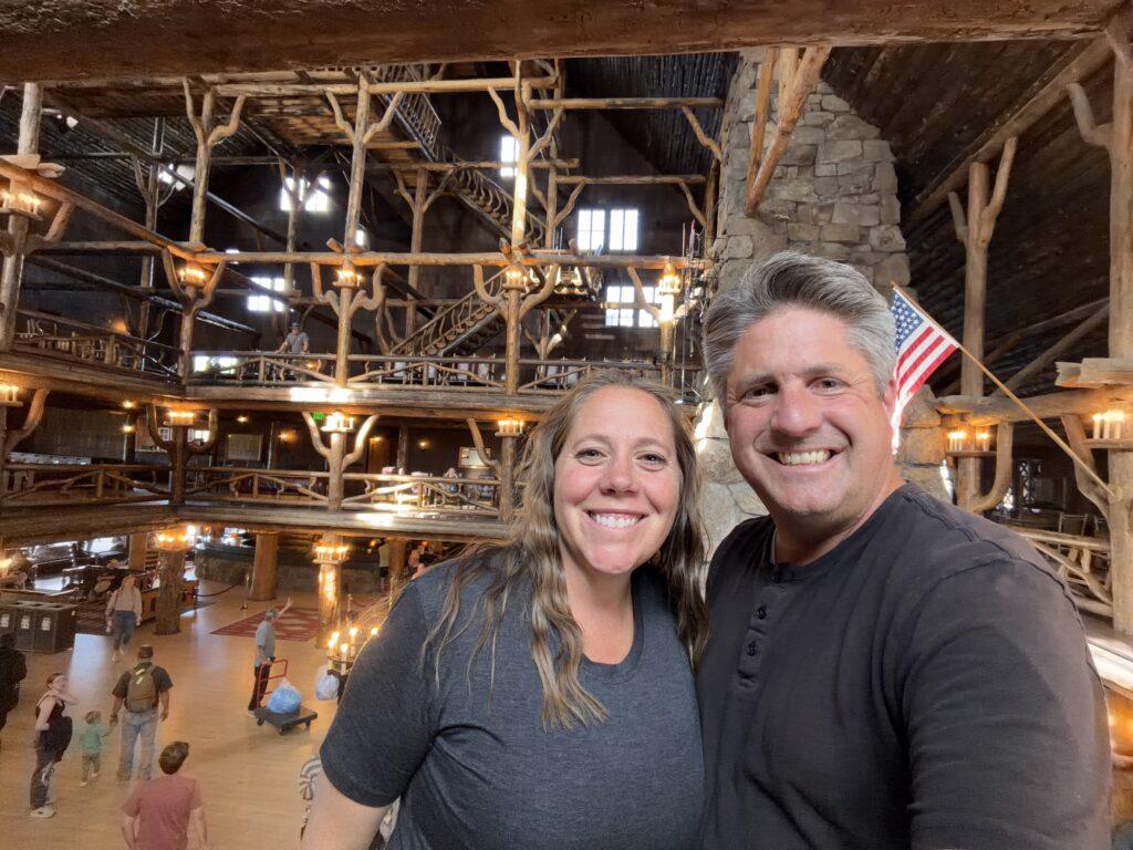 man and woman in Old Faithful Inn lobby