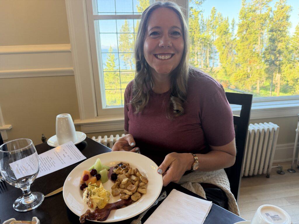 woman sitting at table with plate of food