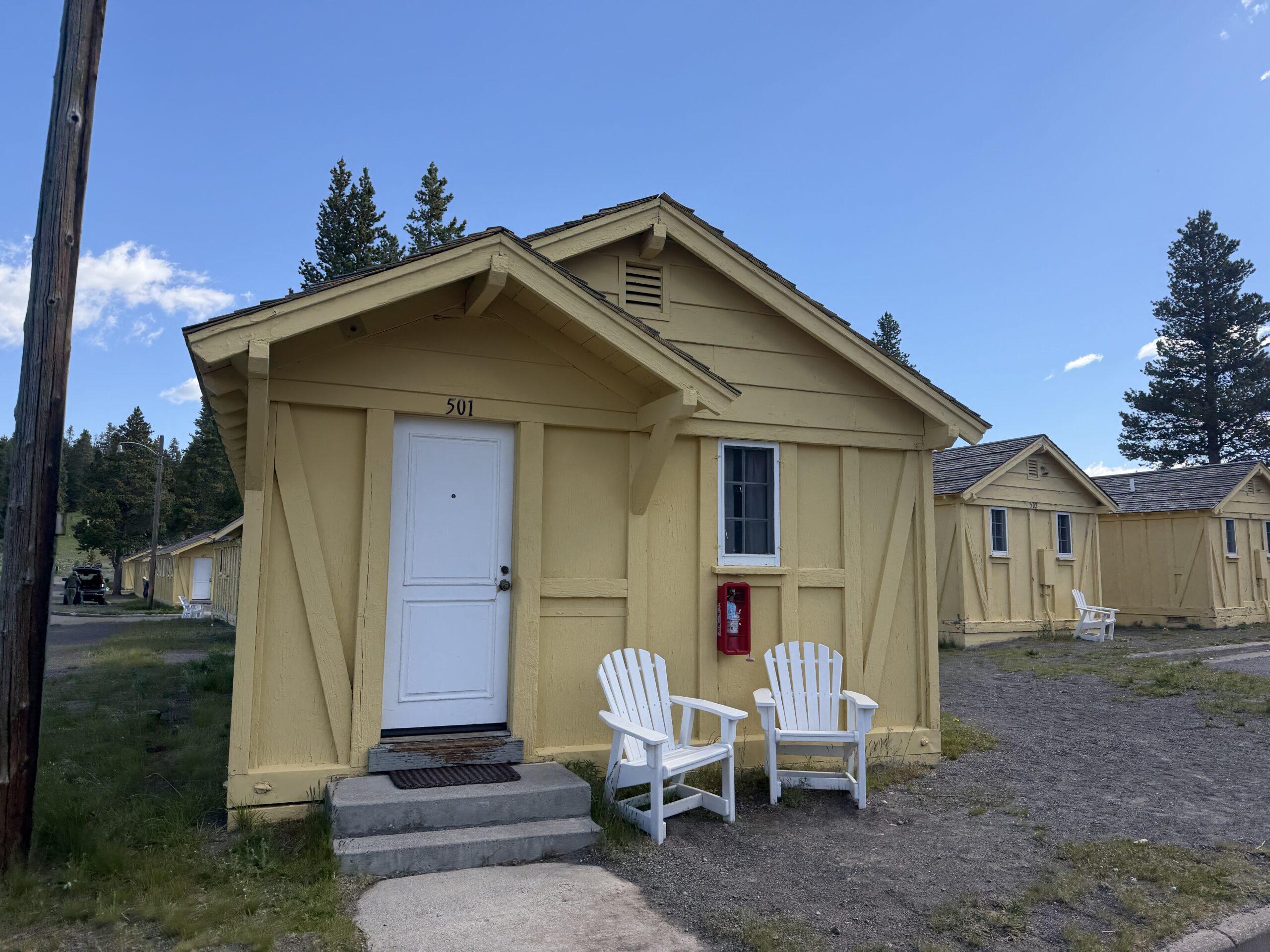 yellow cabin with Adirondack chairs