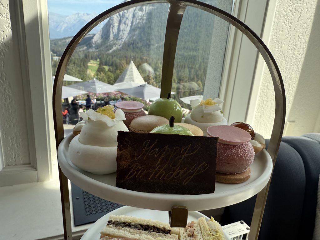 pastries and sandwiches on tiered tray at afternoon tea