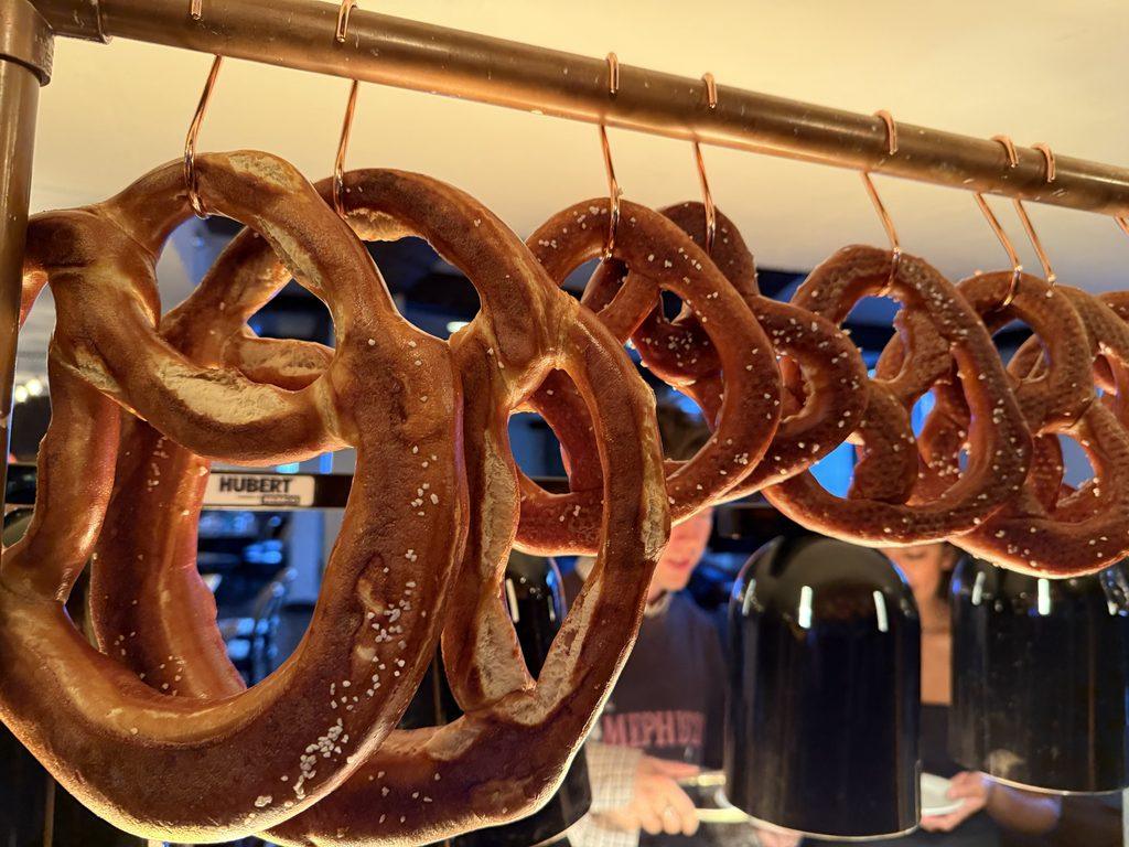 salted soft pretzels hanging on hooks