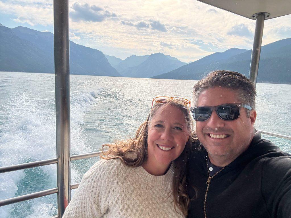 man and woman on boat on lake in mountains