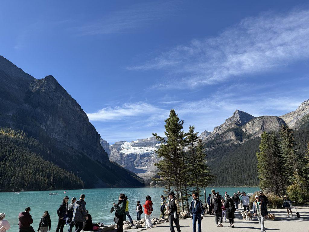 crowd standing in front of lake
