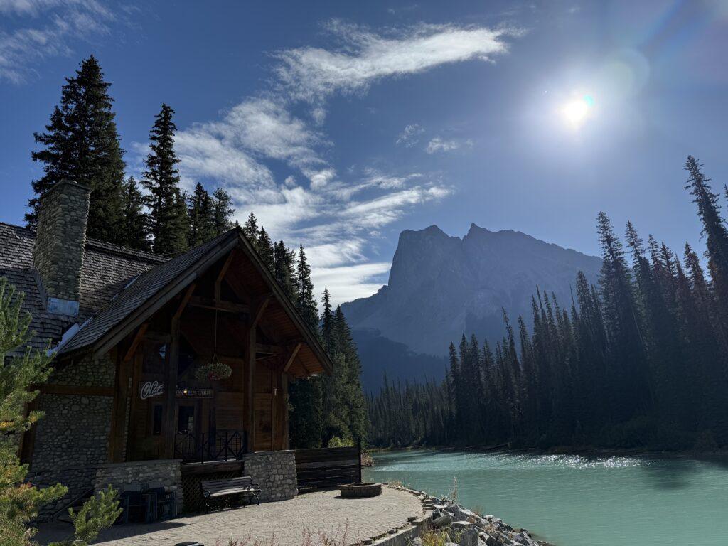 cabin on the edge of green lake in mountains